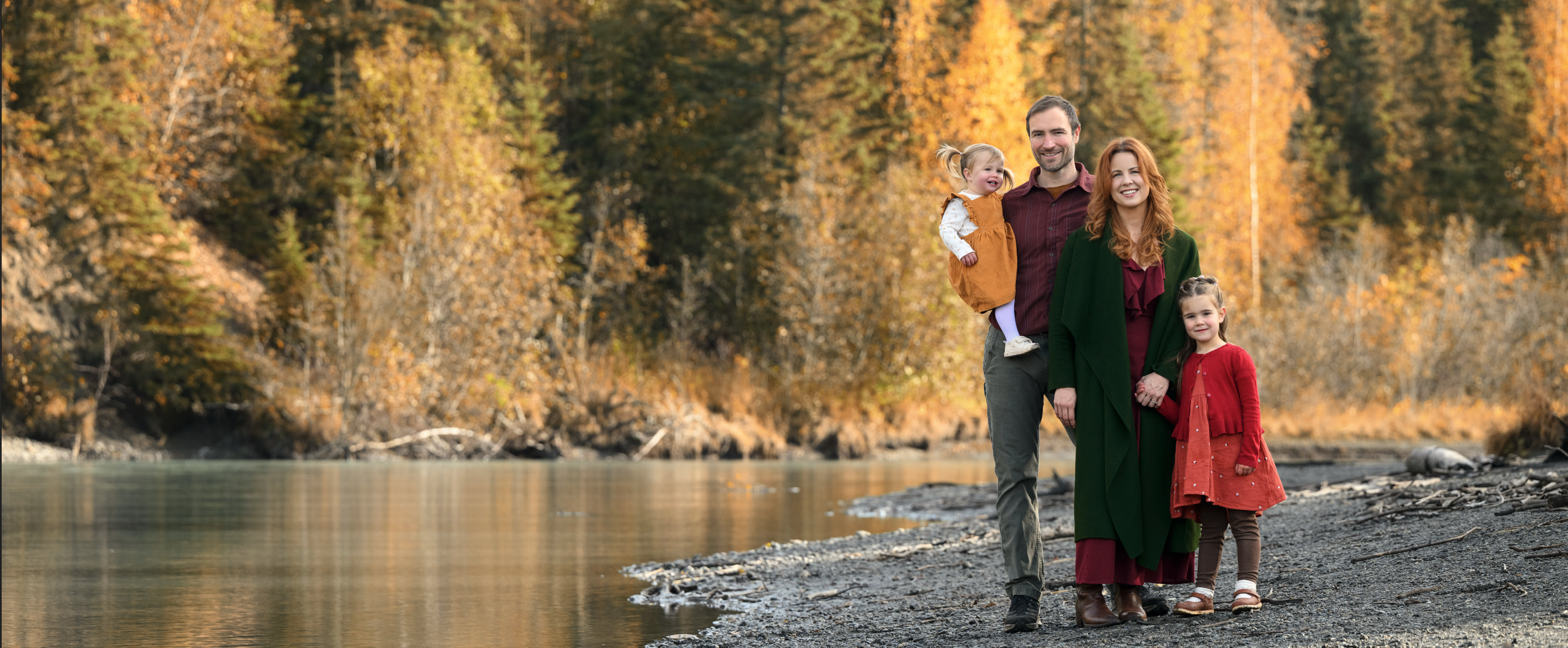 Ruby Jones with her family walking along a riverbank in Eagle River, Alaska during fall